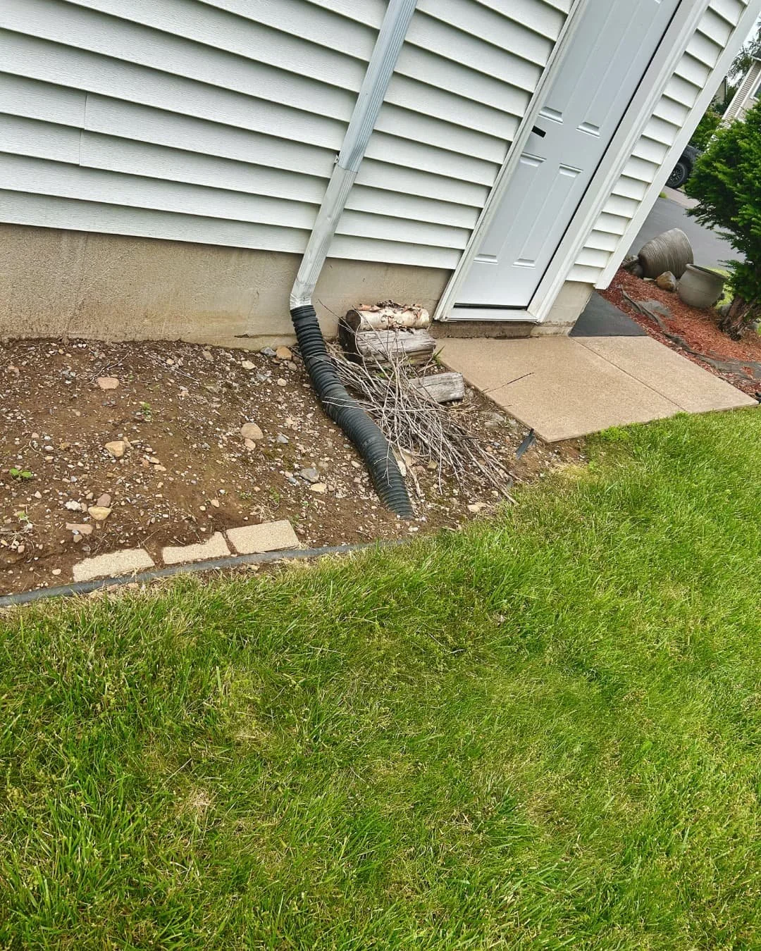 Front entry landscape and walkway before the project by Pines and Pavers in Lysander, New York.
