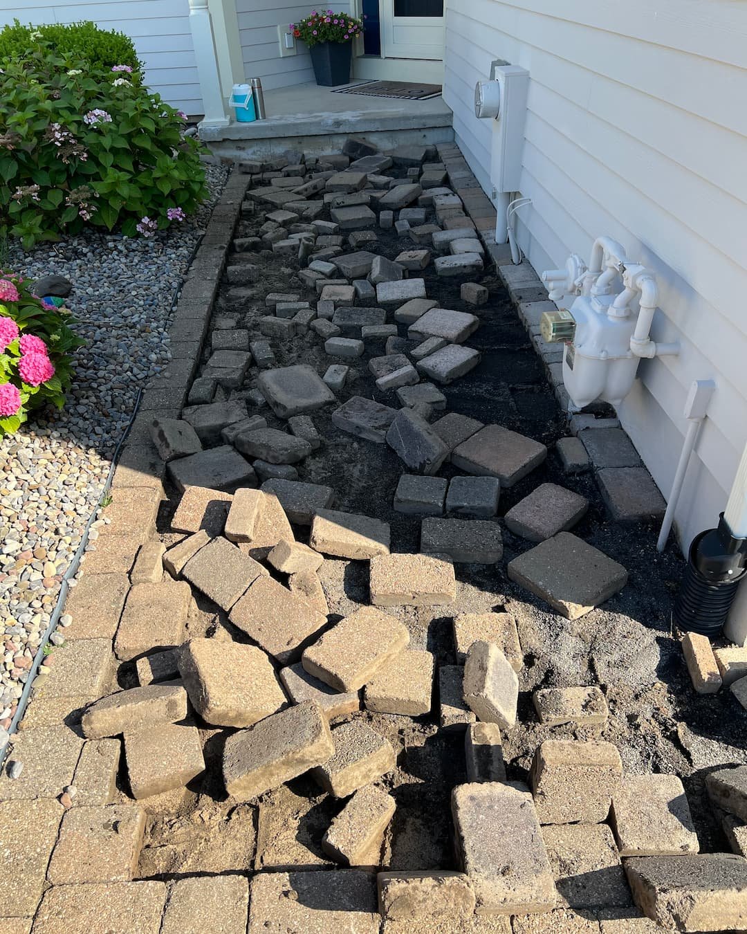 Front drive entry with paver hardscape being updated at a Central New York home.
