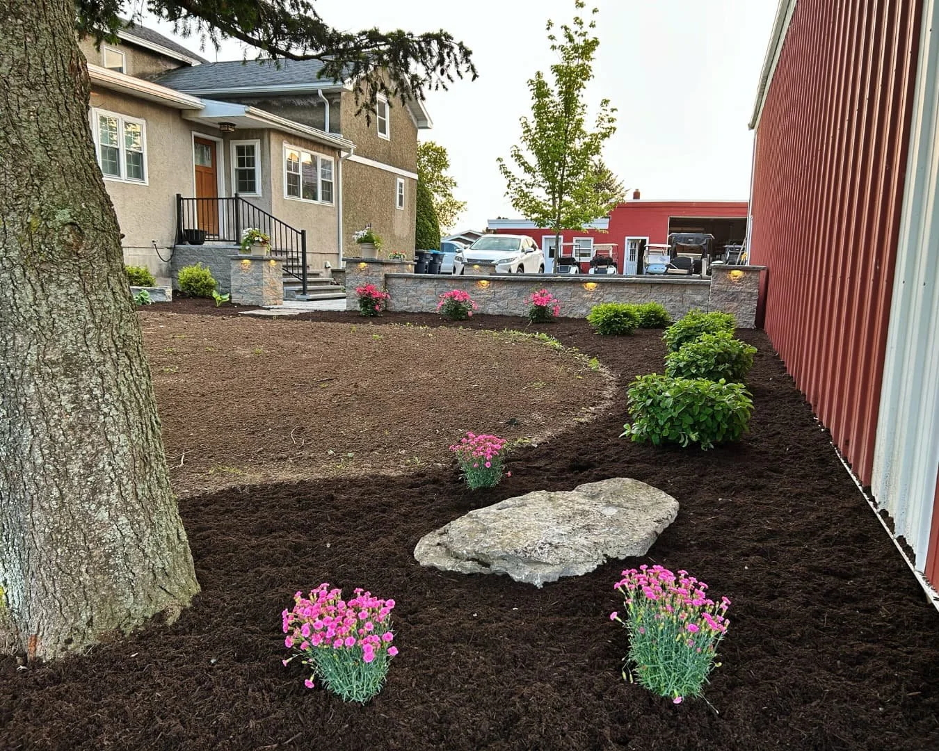 yard landscape bed by the entry steps completed by Pines and Pavers in Fayetteville, New York.