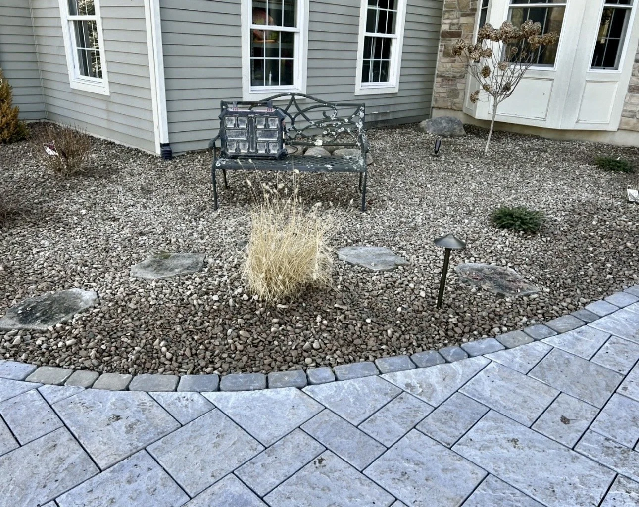 Front foundation landscape beds at a Cazenovia, NY home with fresh mulch and a clean residential setting.