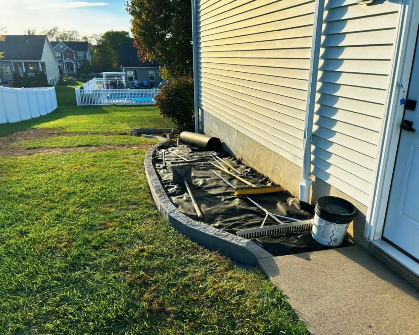 Front foundation landscaping at an Upstate New York home with curved mulch beds and updated curb appeal.