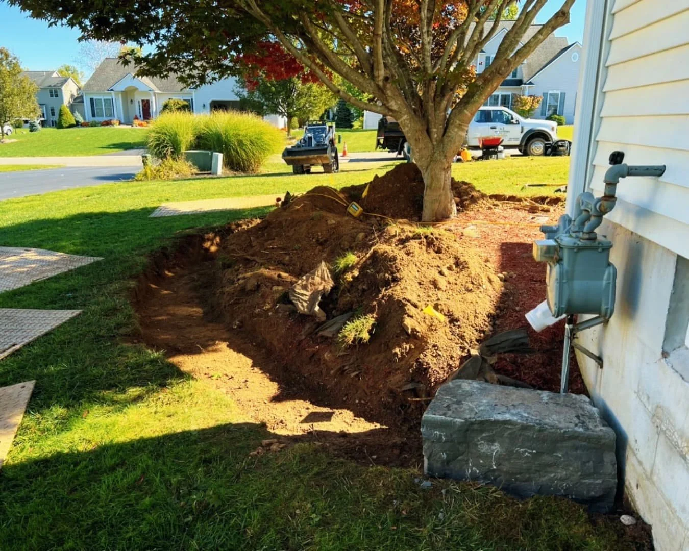 Foundation shrub bed at a Baldwinsville, NY home with fresh mulch and neatly maintained plantings.