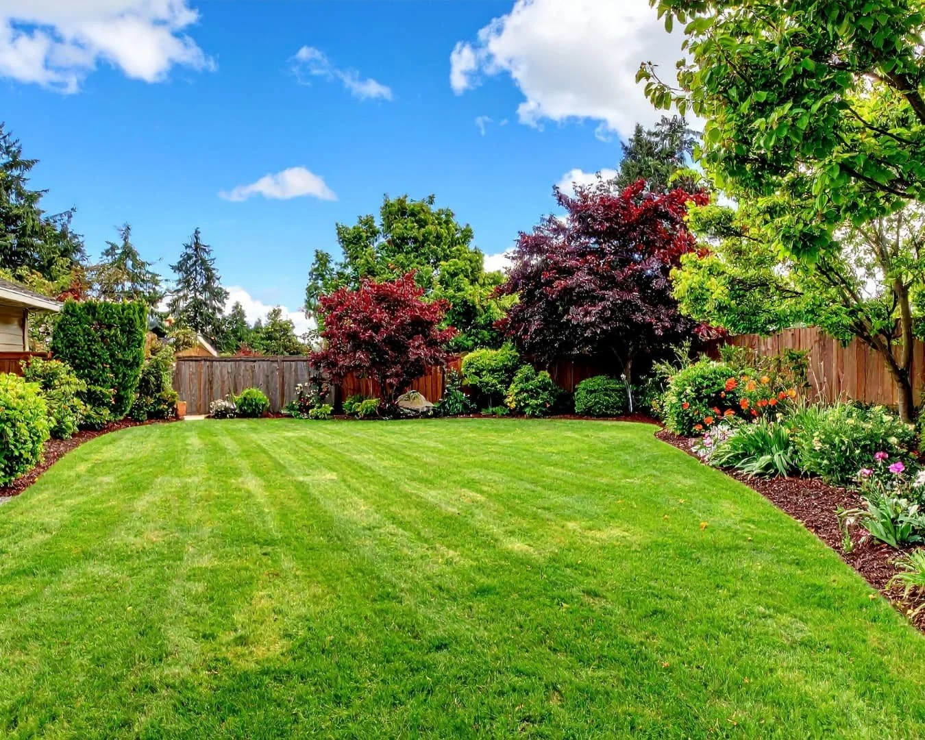 Landscape framing inspiration showing a front yard shaped by clean bed lines and foundation planting.