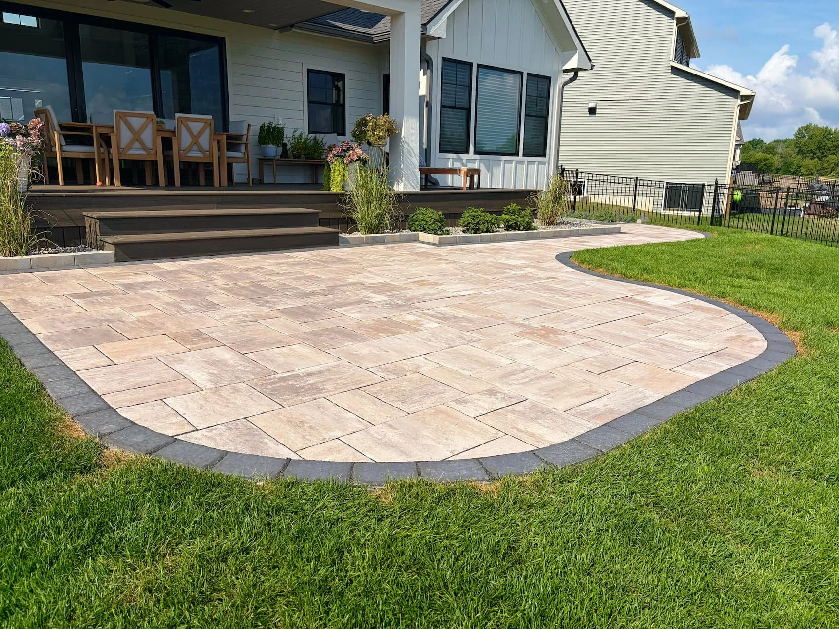 Straight paver walkway alongside a landscaped Central New York home