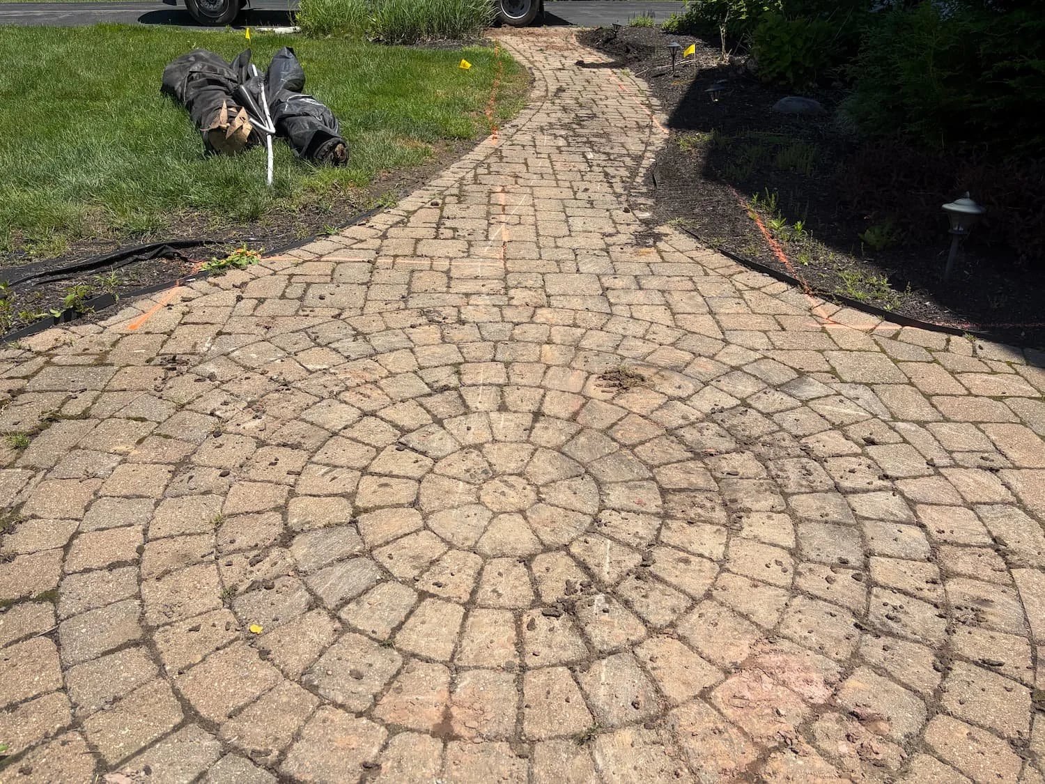 Detailed circular paver pattern incorporated into a custom hardscape walkway in Central NY.