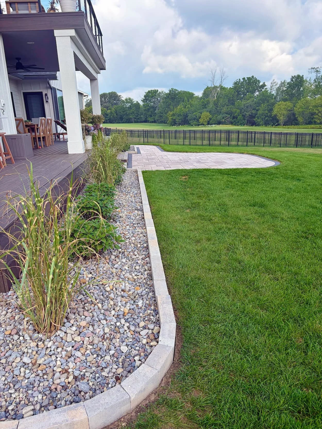 Paver walkway bordered by decorative stone and landscaping in Central New York