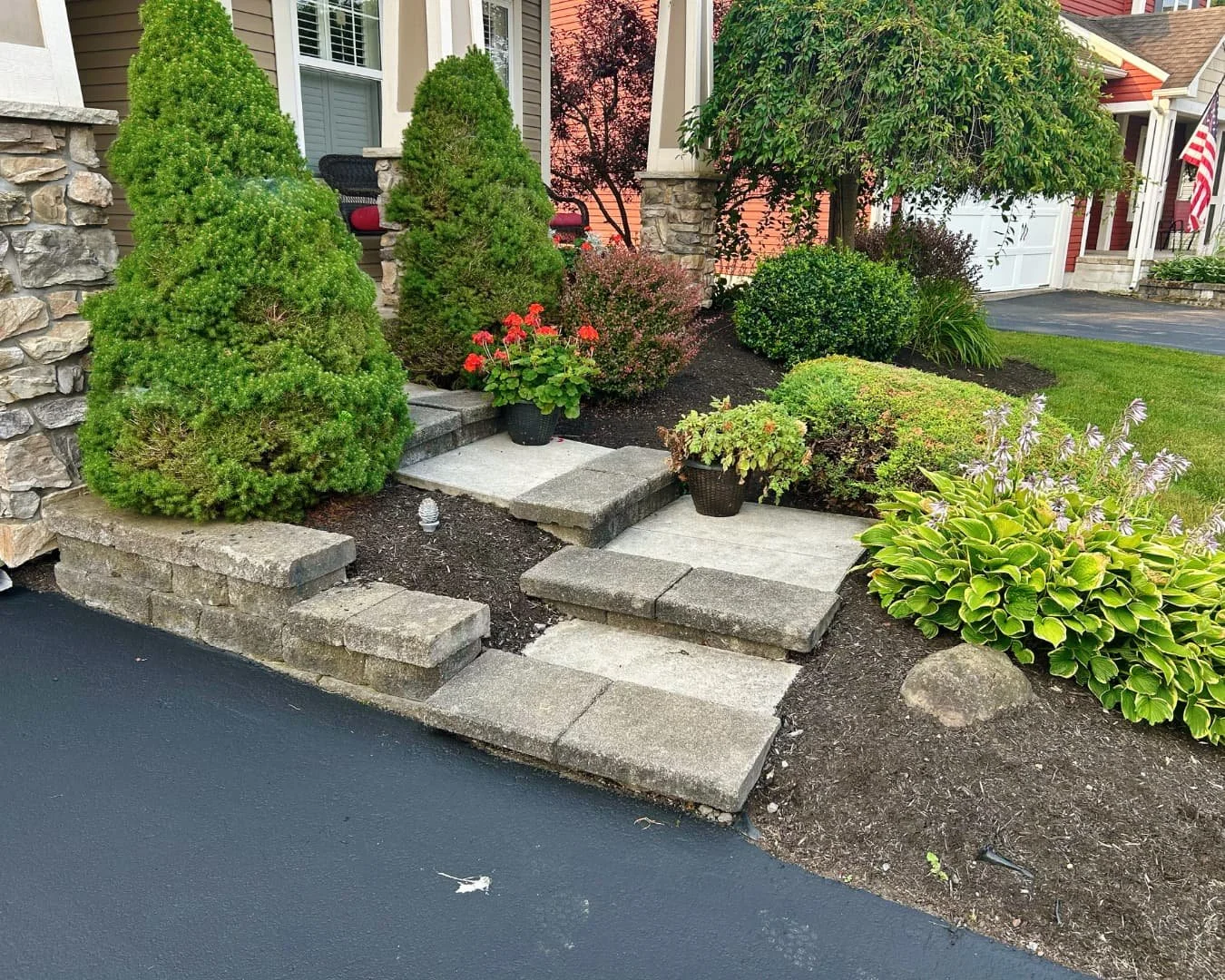 Entry path with stone steps and shrubs completed by Pines and Pavers in Skaneateles Falls, New York.