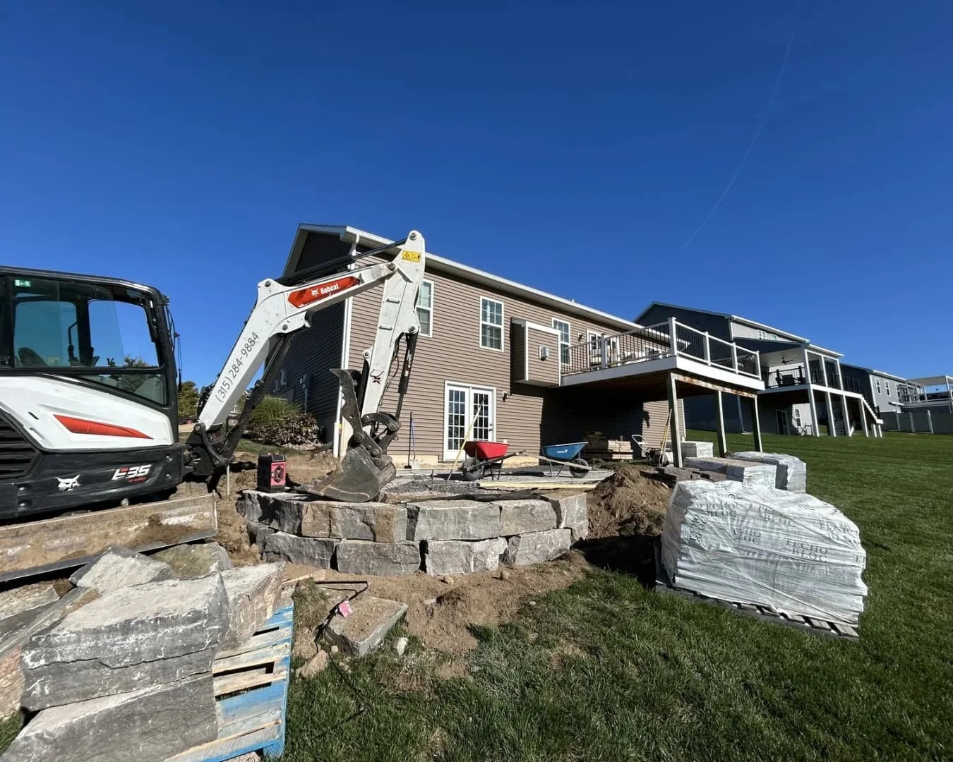 Patio base and side entrance hardscape construction in progress at a Central New York residence.