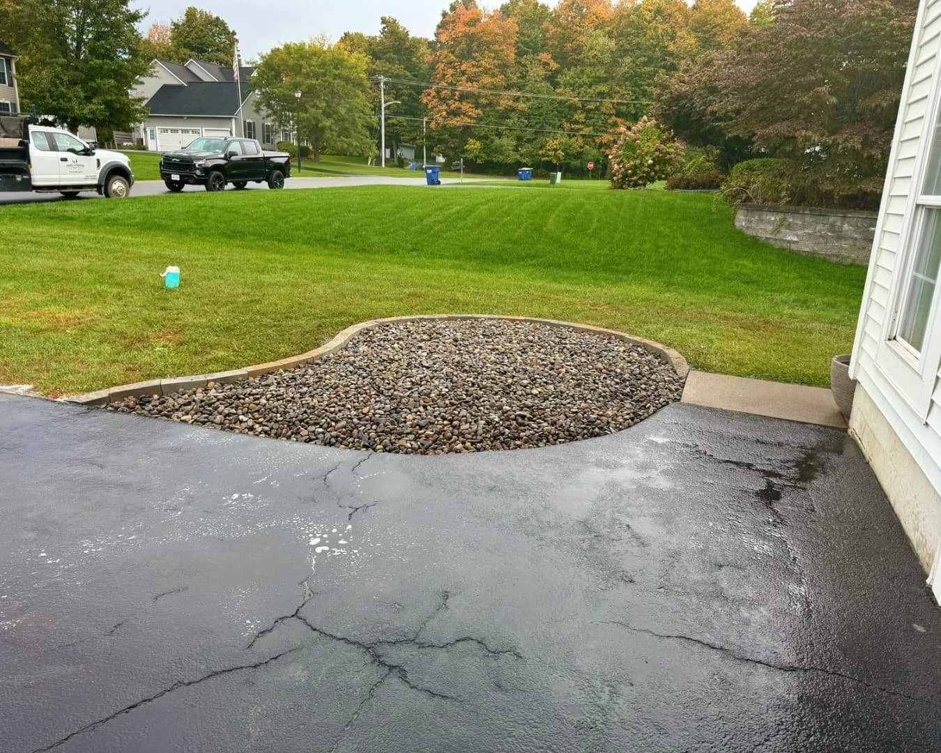 Rear patio and gravel landscape area completed by Pines and Pavers in Lysander, New York.