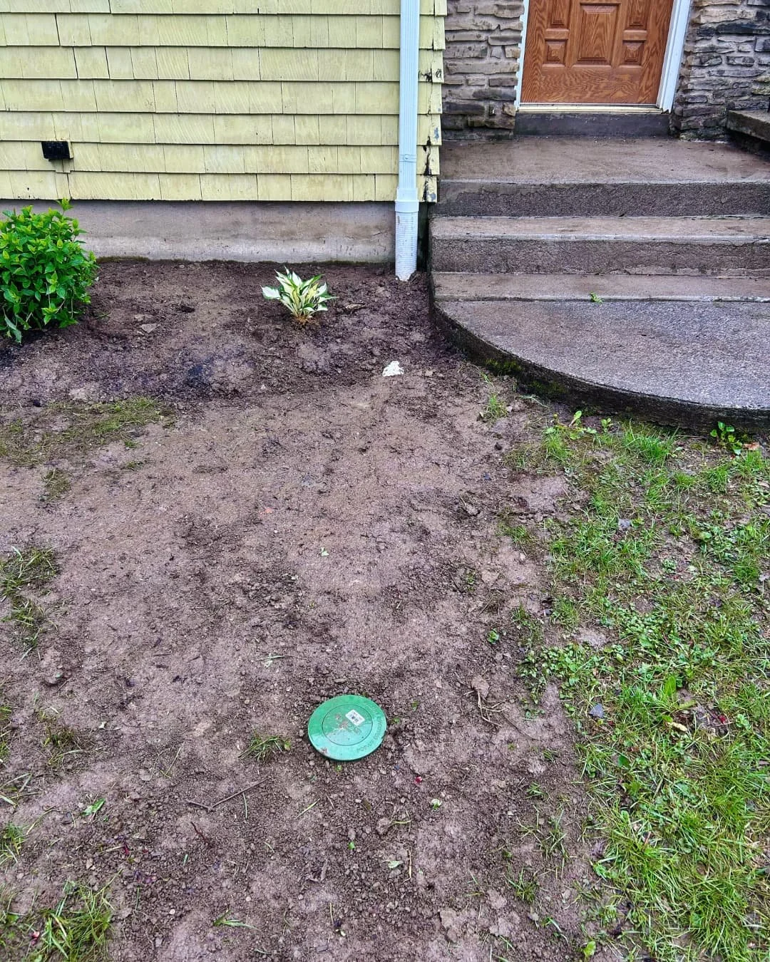 Front entry yard before hardscape installation by Pines and Pavers at a Central New York home.