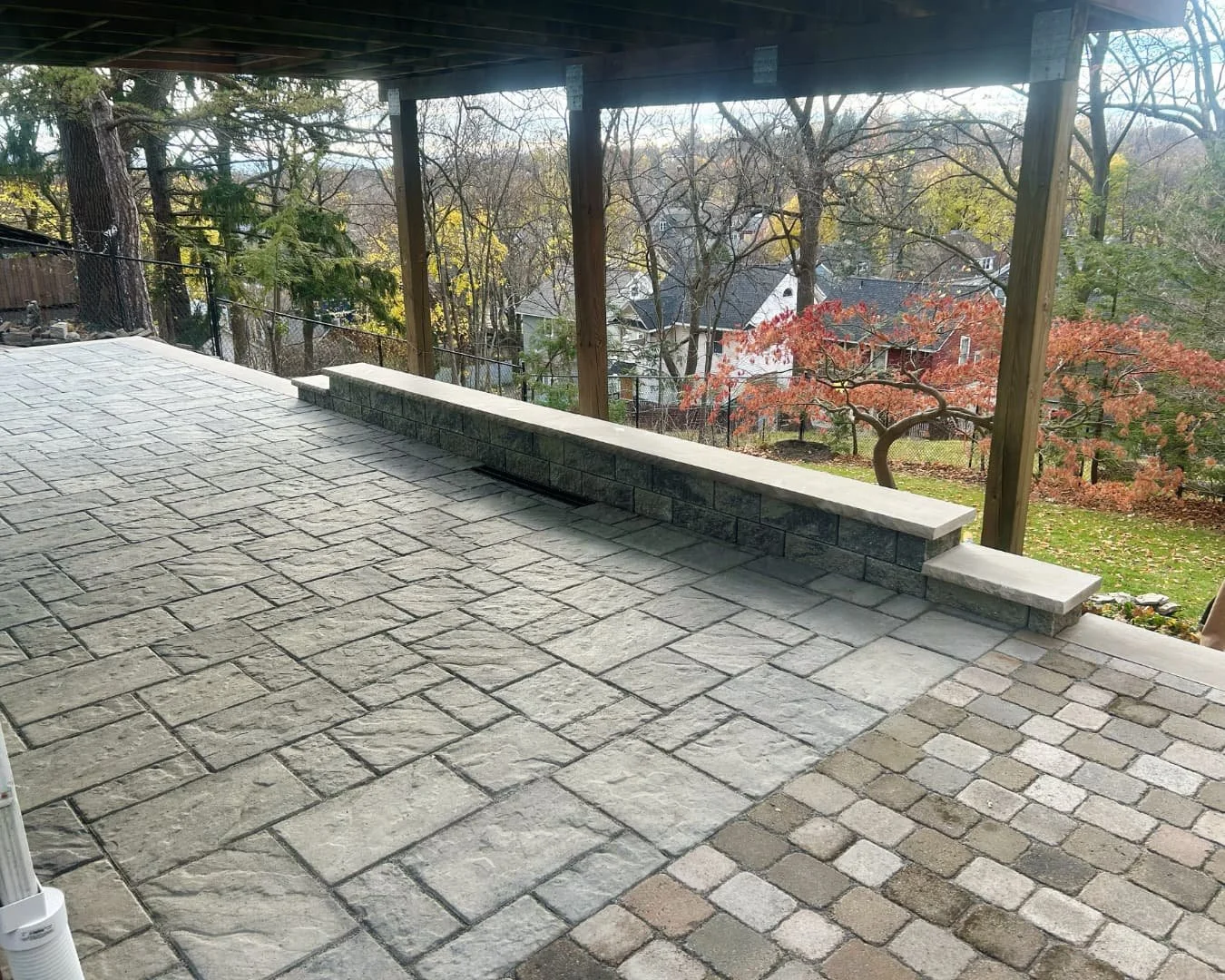 Paver patio installation under a covered deck by Pines and Pavers in Central New York.