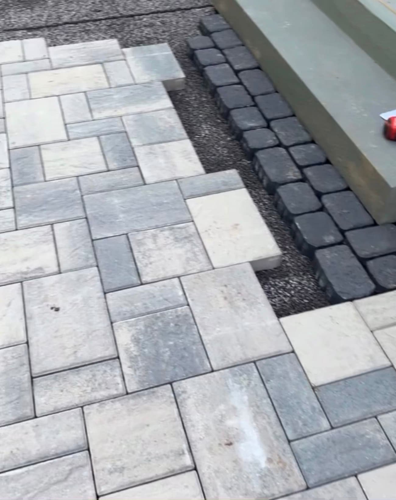 Close-up of a gray paver patio pattern with contrasting border detail on a hardscape project in Central New York.
