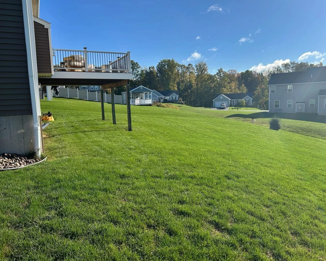 Open backyard before the hardscape project by Pines and Pavers in Lysander, New York.