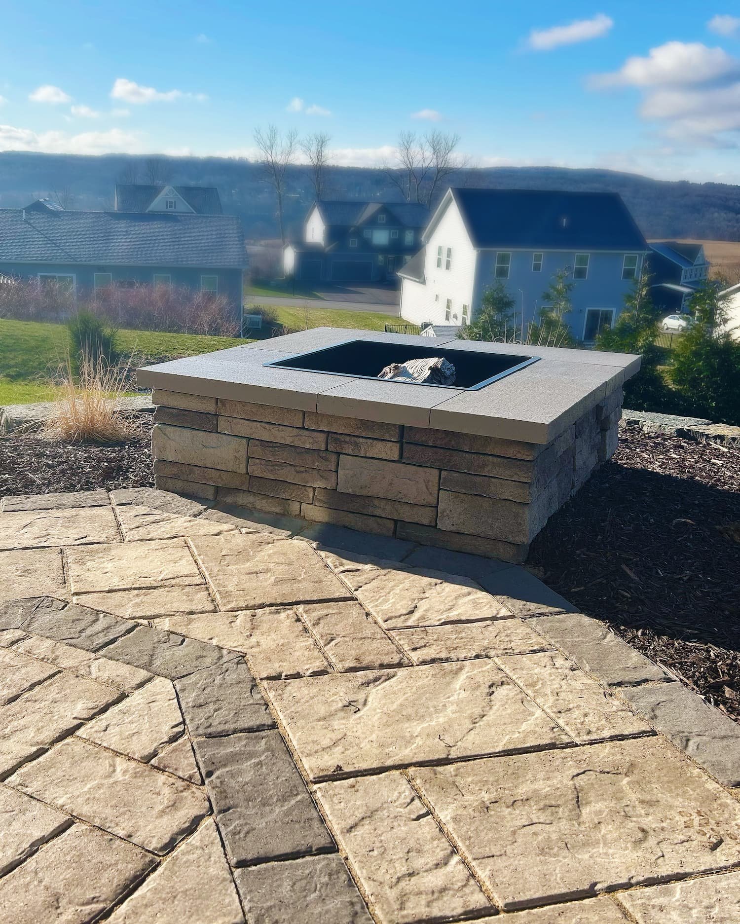 Paver patio with custom fireplace including custom stonework in Central New York