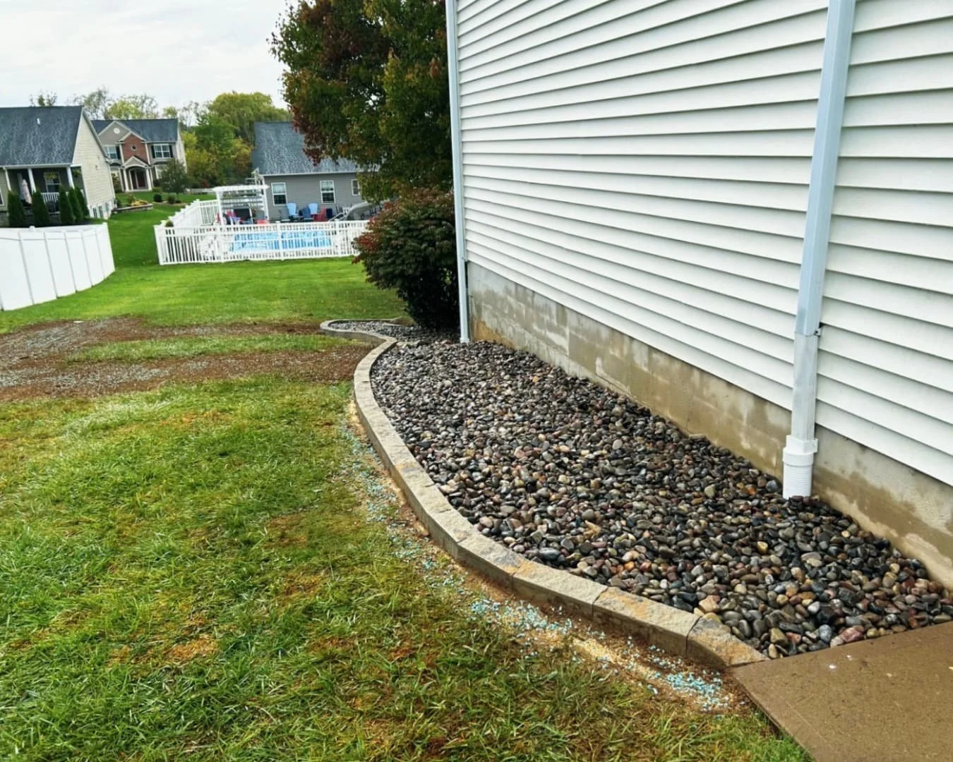 Foundation planting bed at an Upstate New York home with curved mulch edging and refreshed curb appeal.