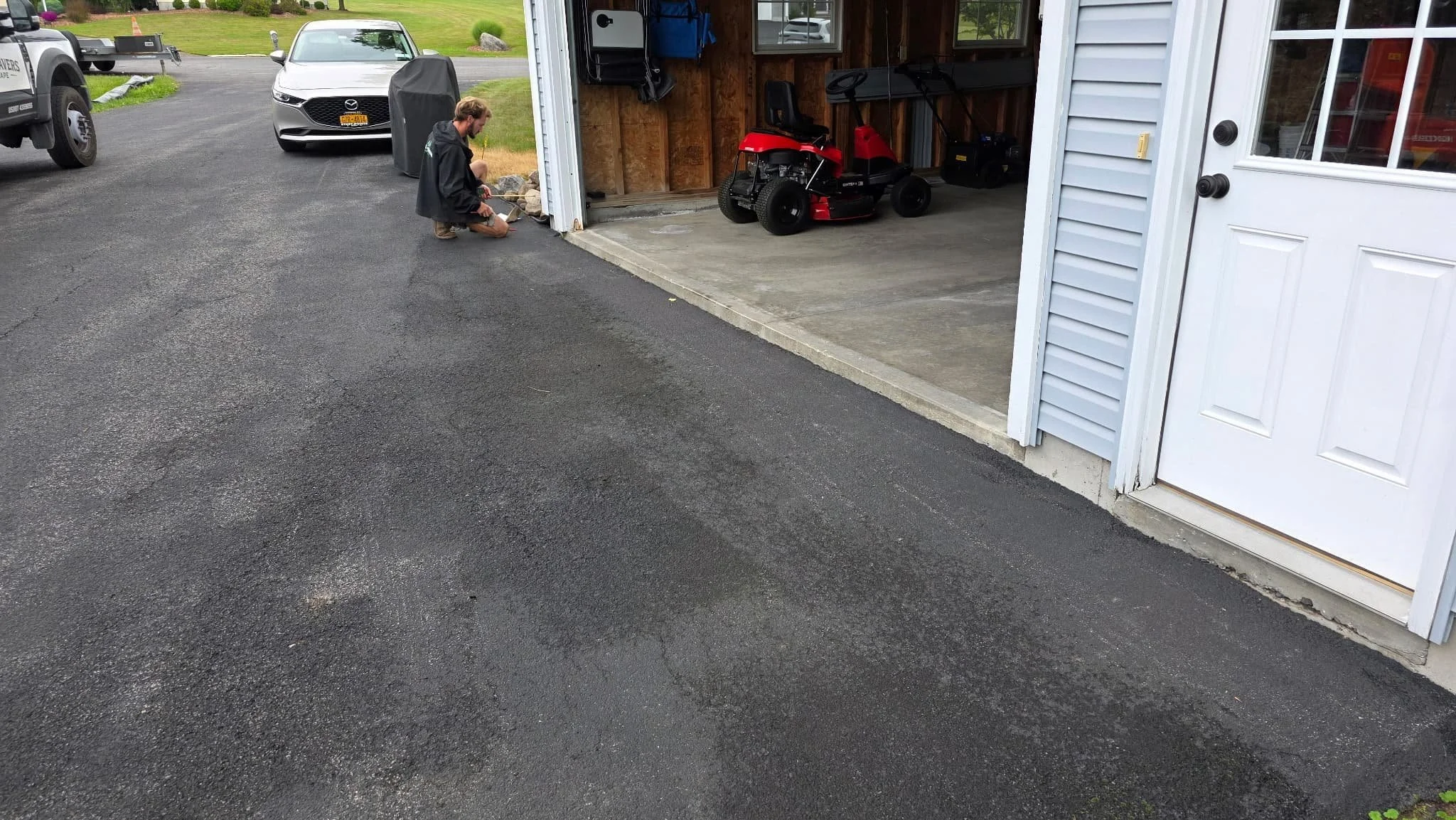 Before view of an existing driveway surface outside a residential garage in Central New York.
