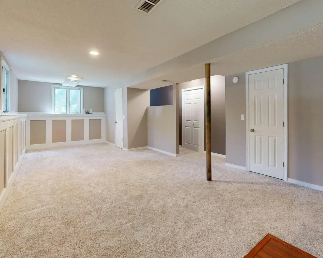Basement inspiration featuring an open finished layout with neutral flooring and flexible living space.