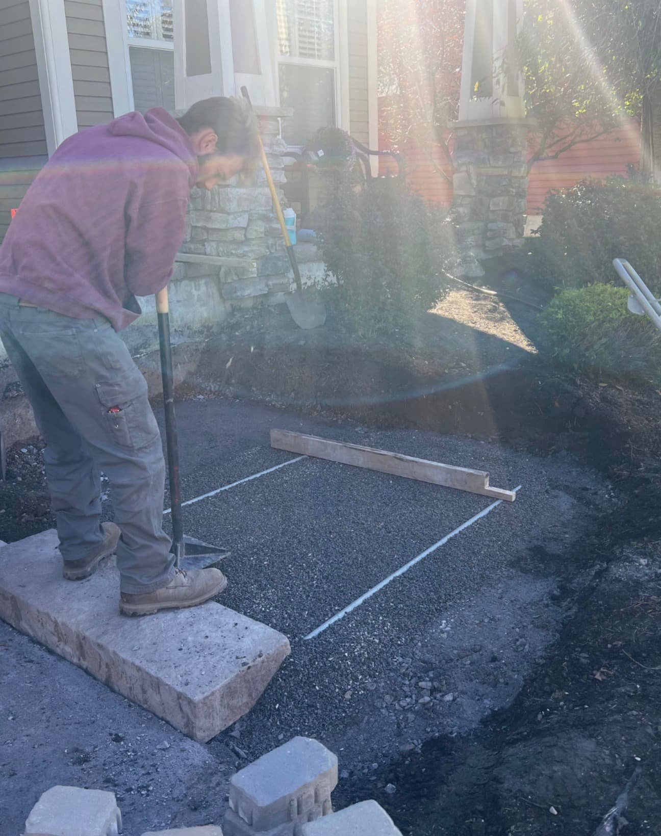 Step installation in progress at a Central New York home with active hardscape construction near the front entry.