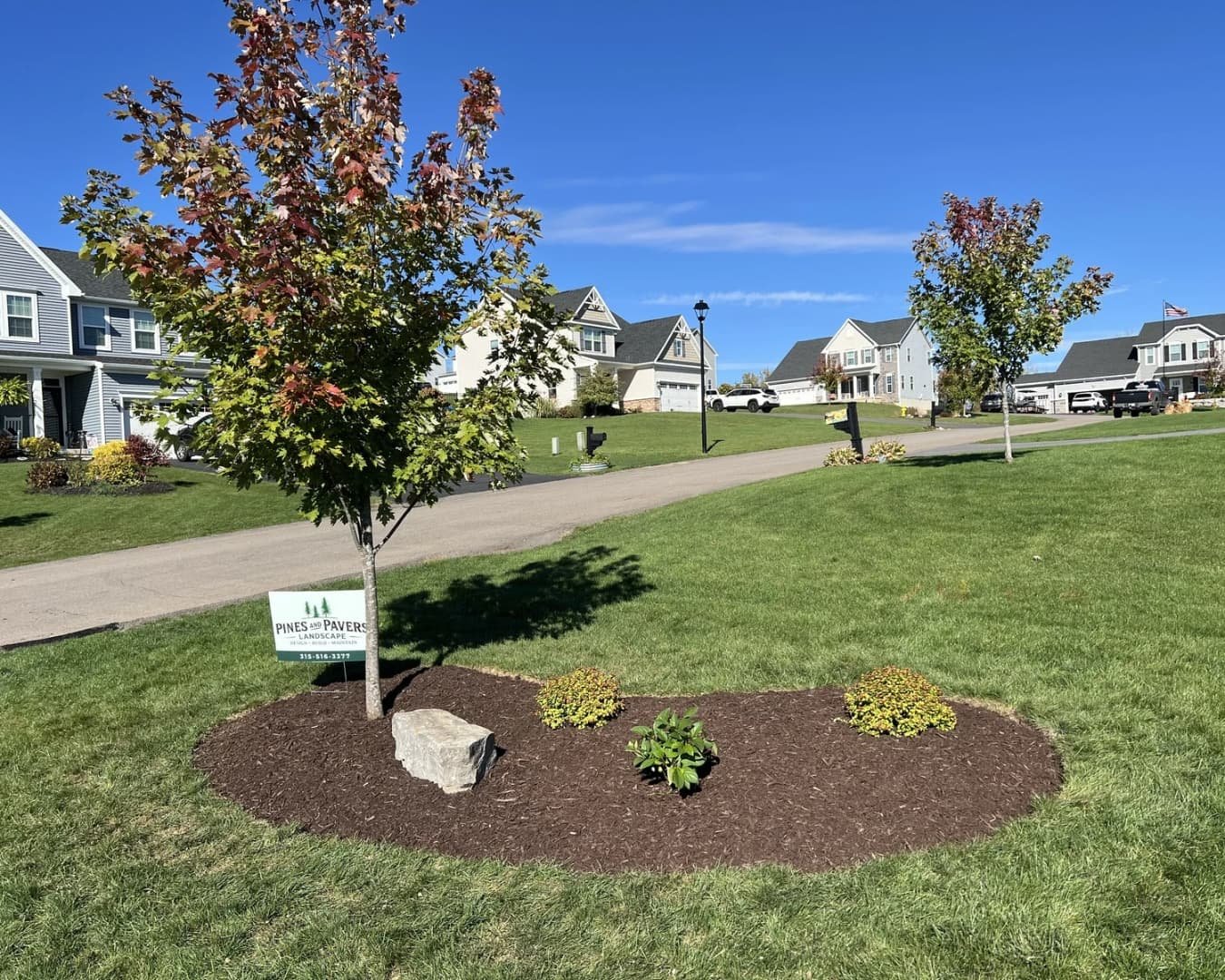 Finished backyard paver patio and walkway at a Central New York home with clean lines and open lawn views.