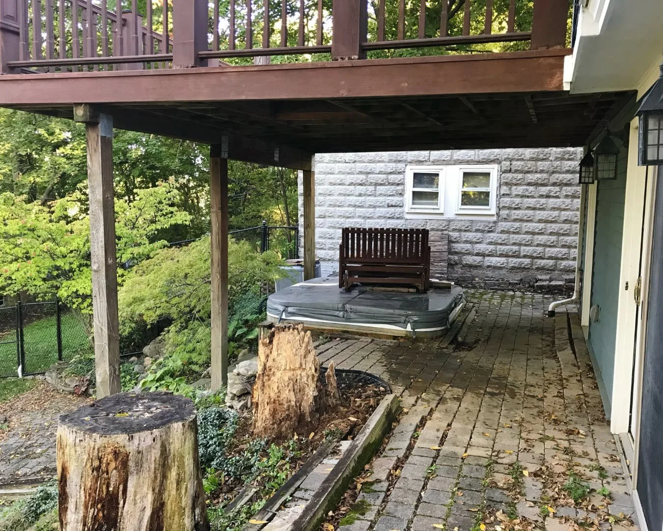 Existing patio area beside the home before renovation by Pines and Pavers in Central New York.