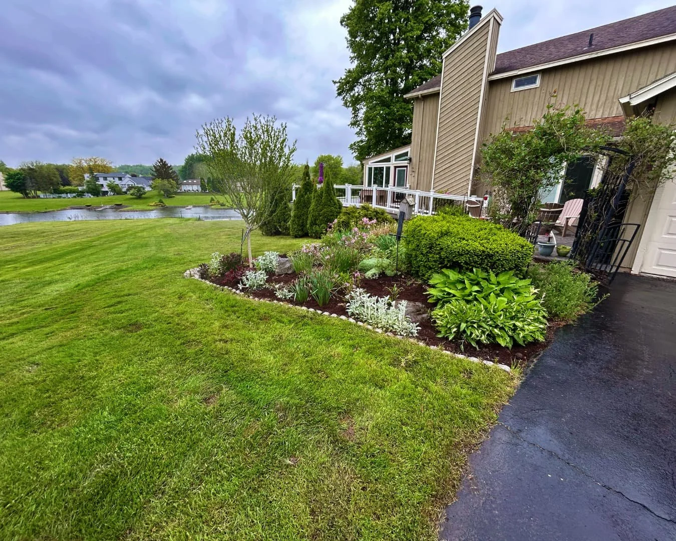 Curved landscape bed border completed by Pines and Pavers in Skaneateles, New York.