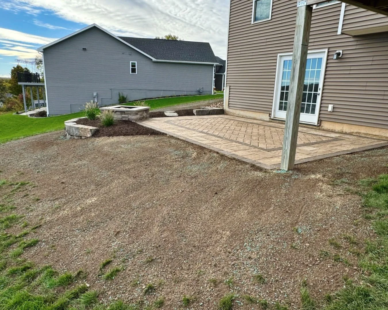 Rear patio and open yard overview completed by Pines and Pavers in Lysander, New York.