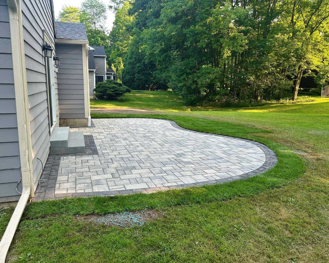 Backyard hardscape overview completed by Pines and Pavers in Baldwinsville, New York.
