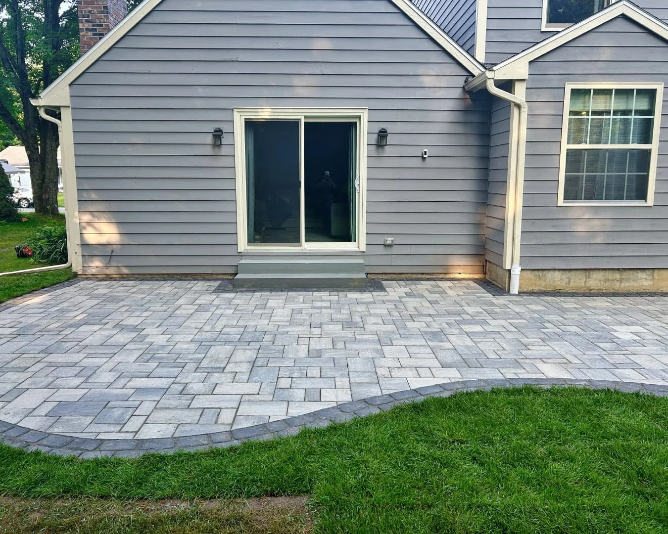Backyard paver patio overview completed by Pines and Pavers in Baldwinsville, New York.