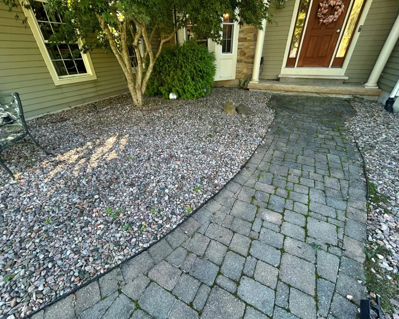 Curved front walkway and entry by Pines and Pavers in Fayetteville, New York.