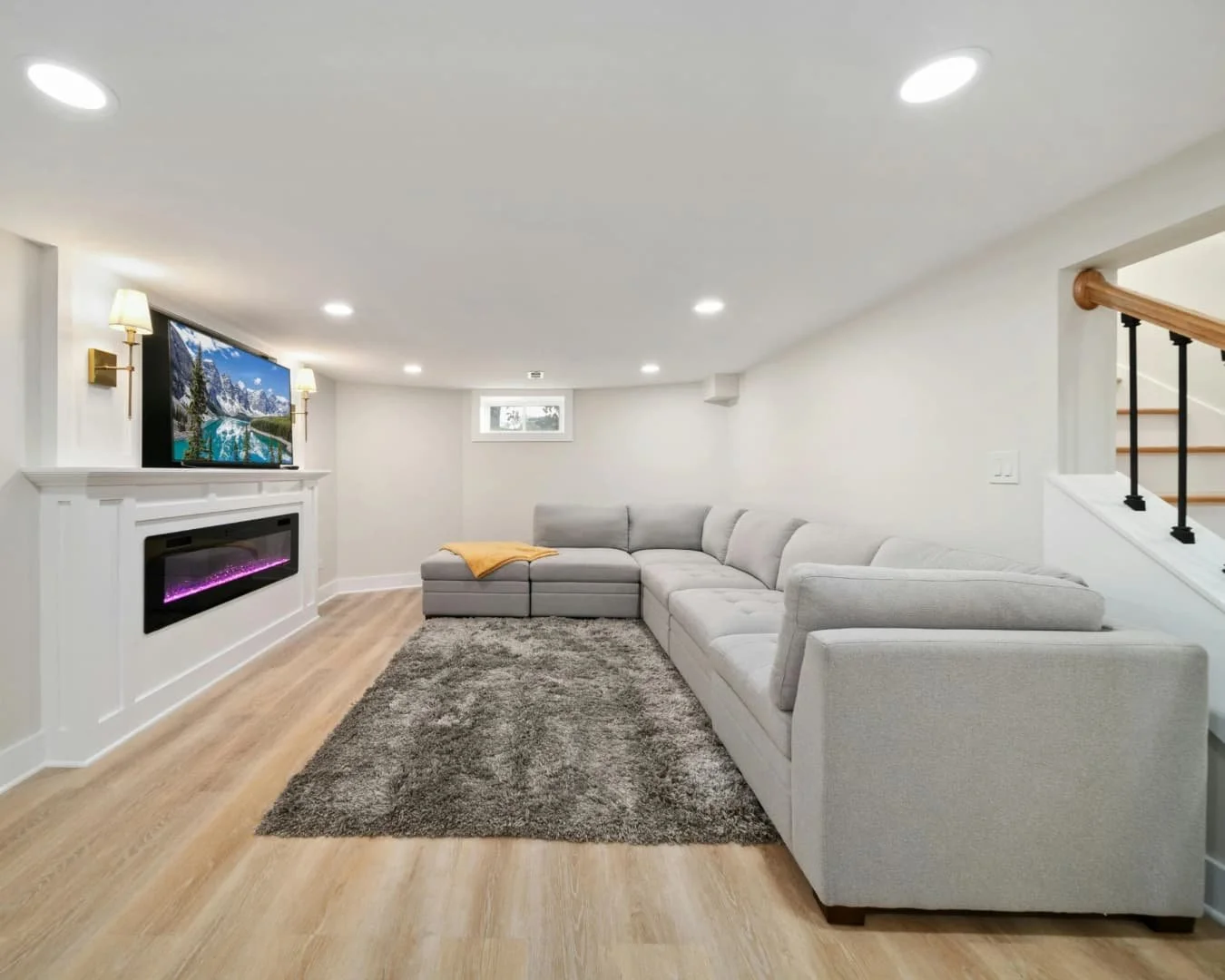 Finished basement inspiration with staircase access, soft wall color, and a comfortable lower-level seating area.