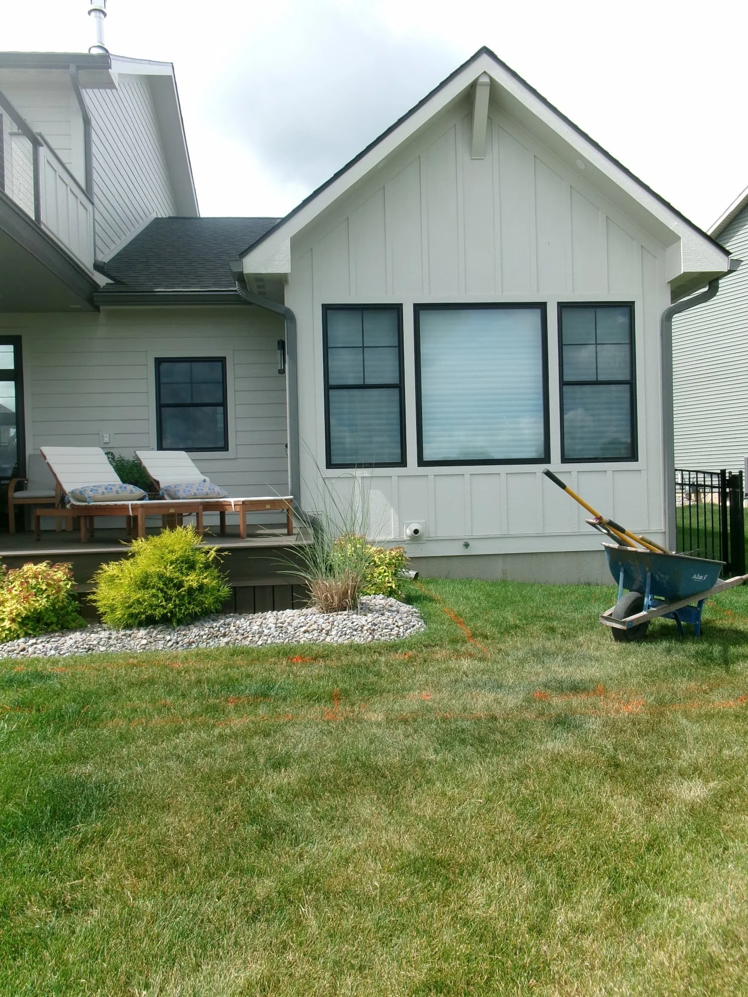 Backyard before patio and landscape improvements showing an open lawn area in Central New York