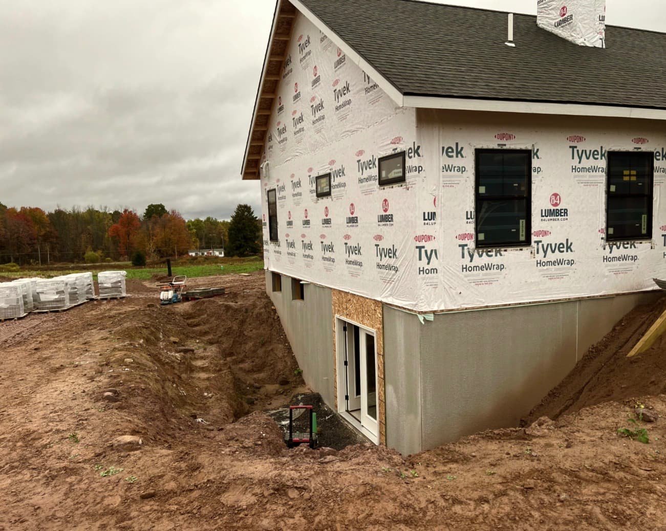 Entry landing and walkway installation at an Upstate New York home with new stonework and surrounding site prep.