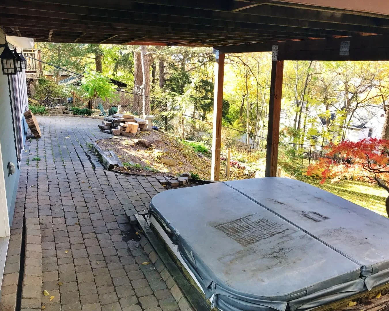 Existing paver surface with visible weed growth before renovation by Pines and Pavers in Central New York.