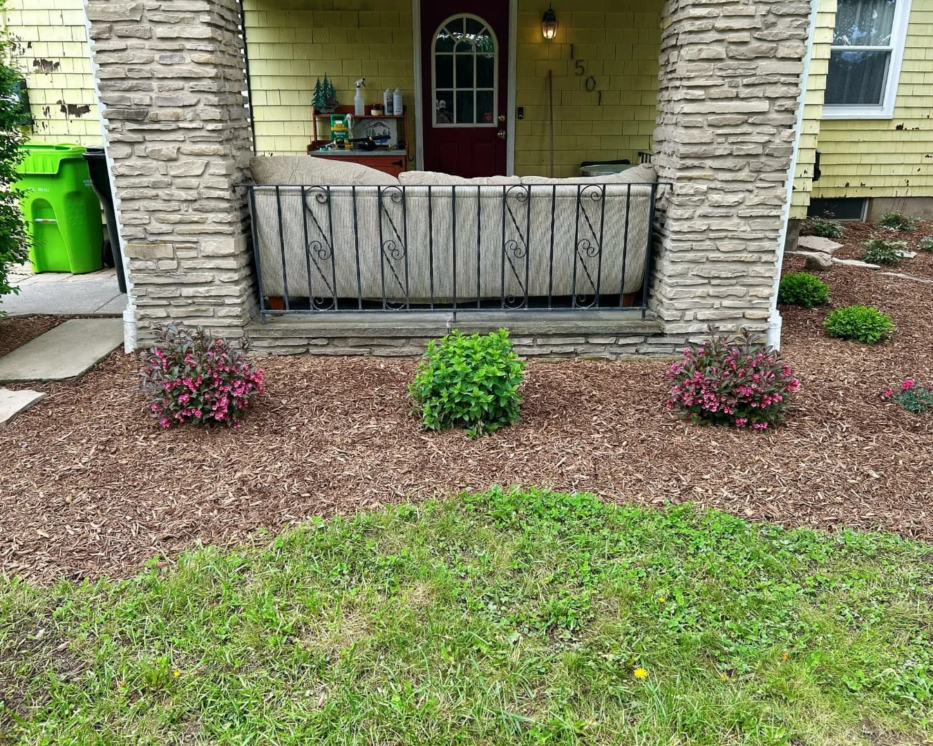 Front entry landscape bed and porch area completed by Pines and Pavers at a Central New York home.