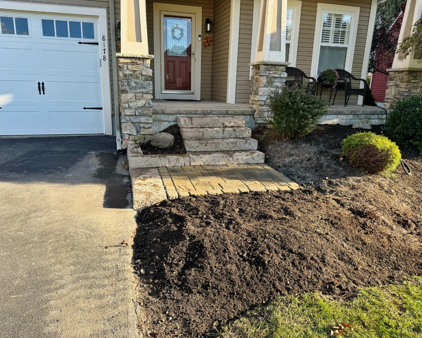 Natural stone entry steps with paver landing completed by Pines and Pavers in Skaneateles Falls, New York.