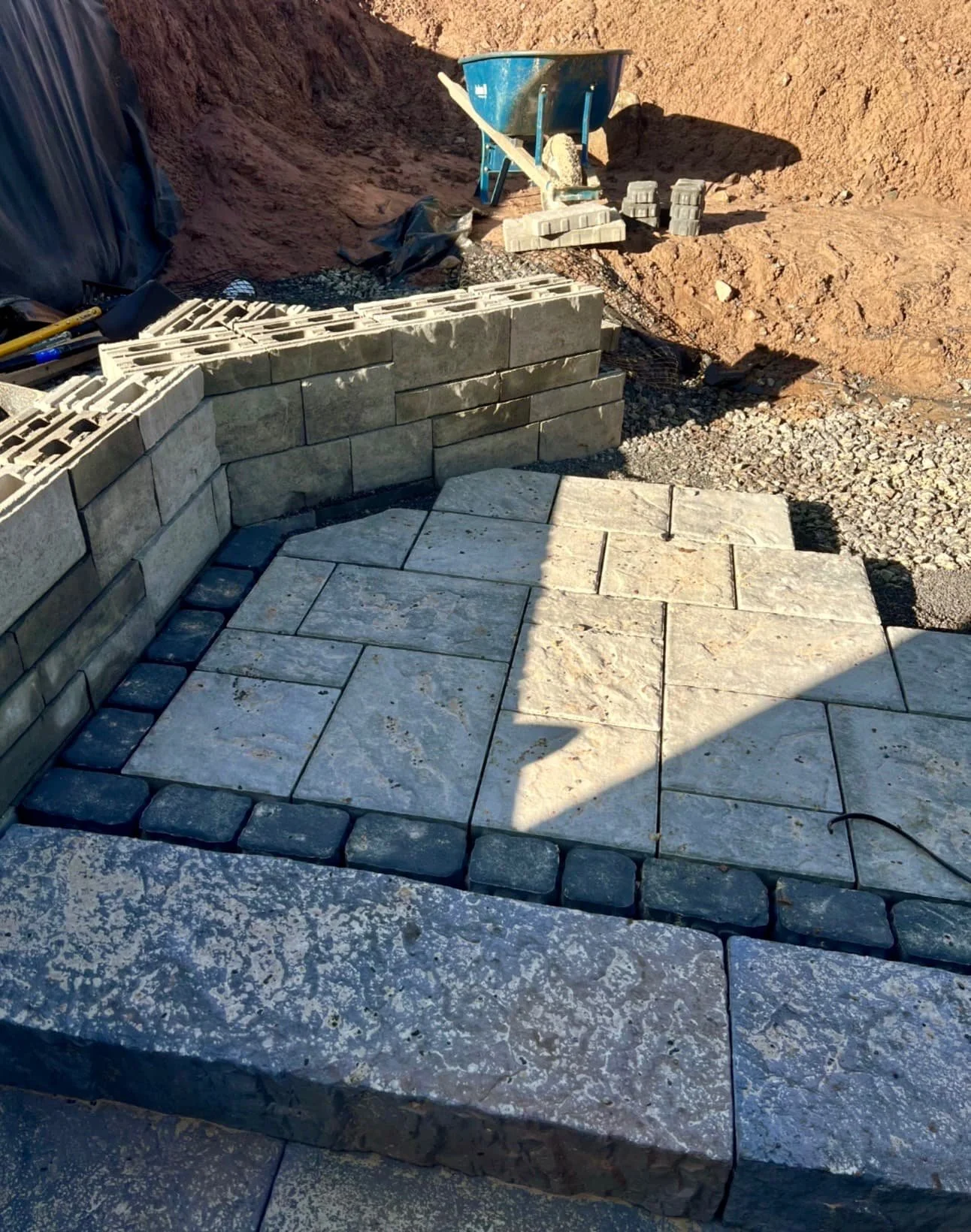 Side yard hardscape construction at a Skaneateles, NY home with excavation and grading around a new entry design.