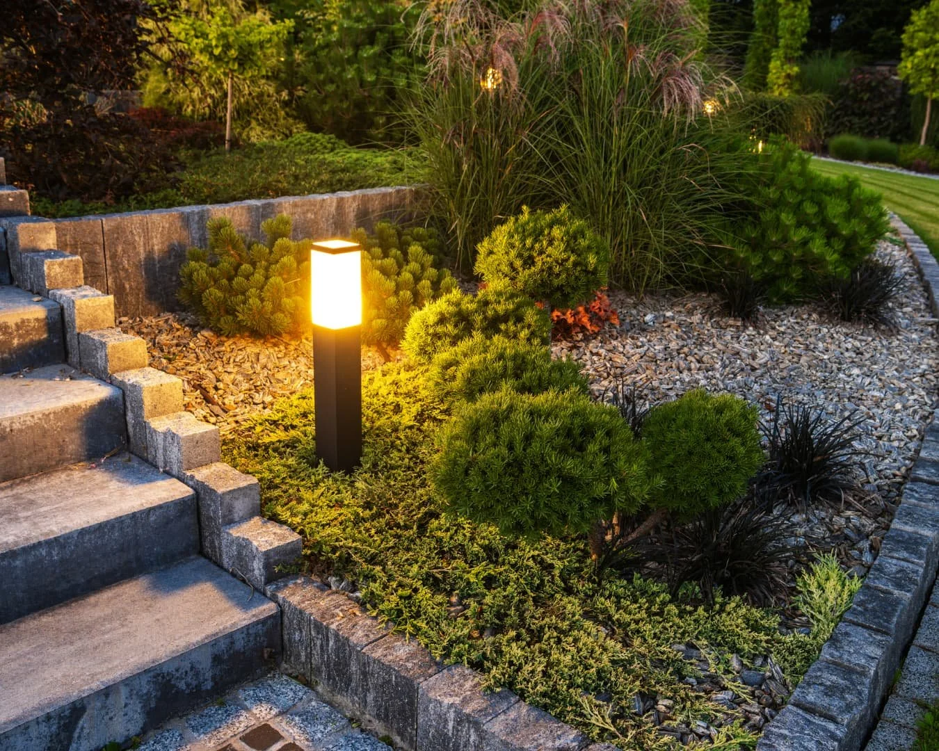 Layered landscaping inspiration with walkway-side planting, clipped shrubs, and foundation beds creating a polished entry edge.