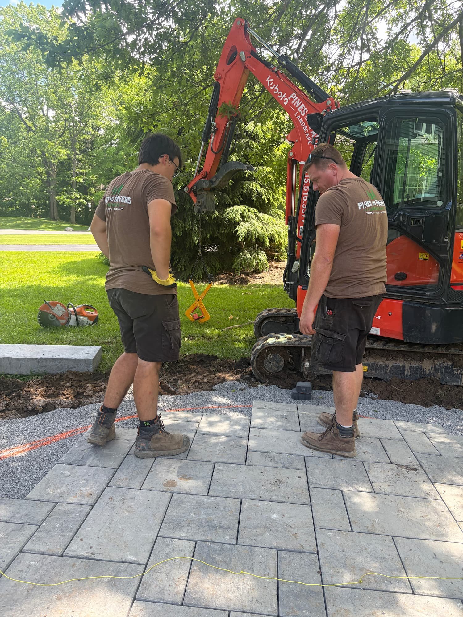 Detailed paver placement and alignment during a professional patio installation in Central New York.