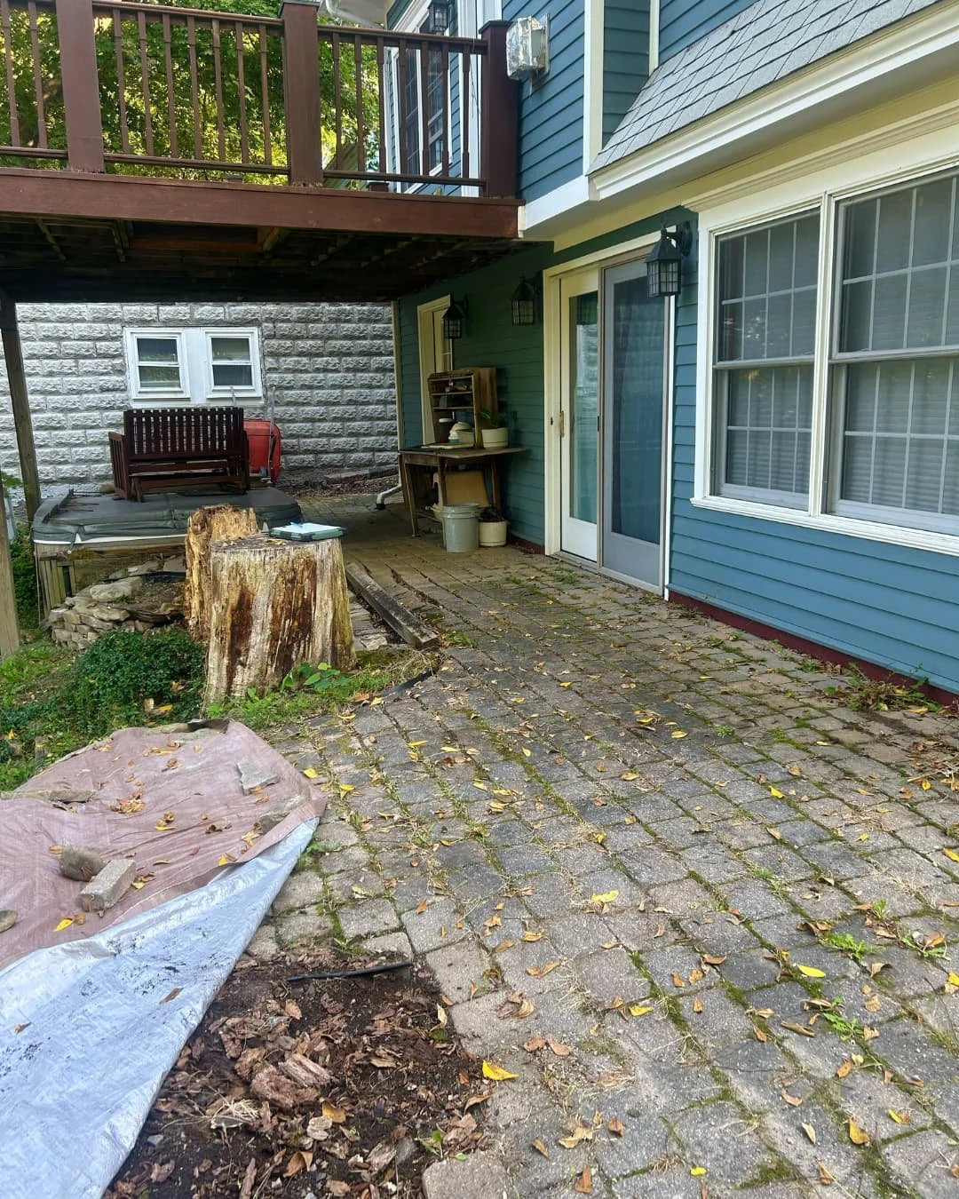 Existing under-deck patio space before construction by Pines and Pavers in Central New York.