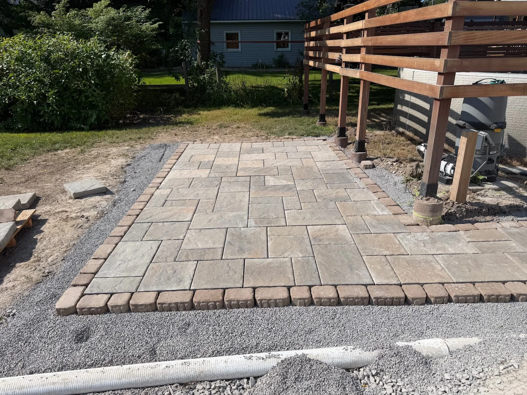 Landscape bed area being prepared alongside a residential deck in Central New York.