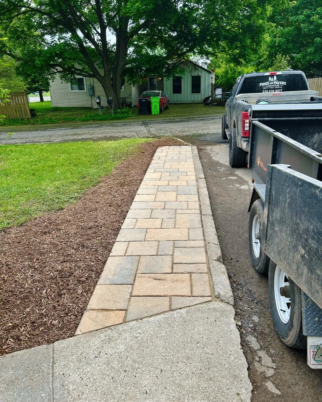 Straight paver walkway installed beside the driveway by Pines and Pavers in Central New York.