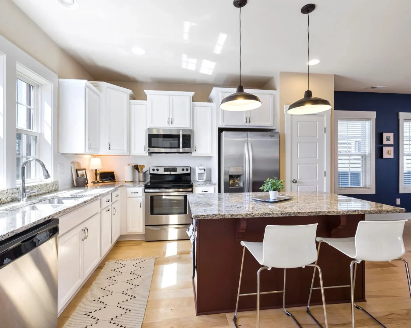 Kitchen inspiration with white cabinetry, a central island, and warm layered lighting.