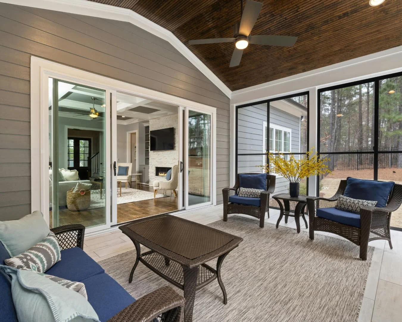 Sunroom inspiration with a wood ceiling, screened views, and relaxed seating for indoor-outdoor living.