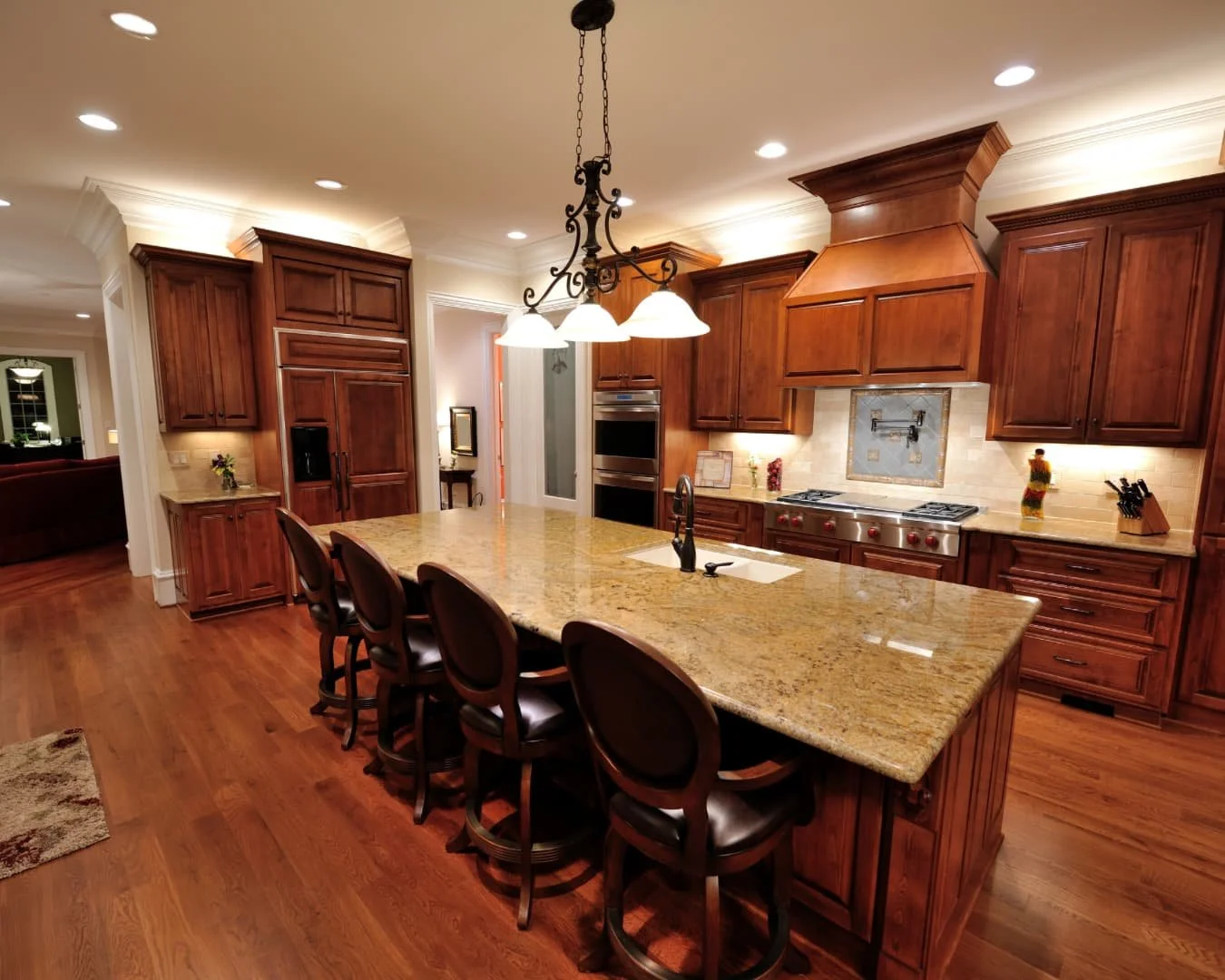 Kitchen inspiration with a large wood island, rich cabinetry, and an open layout for cooking and entertaining.
