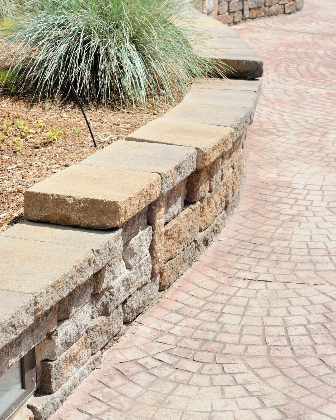 Raised garden bed inspiration with a front entry flower bed framed by low stone edging.