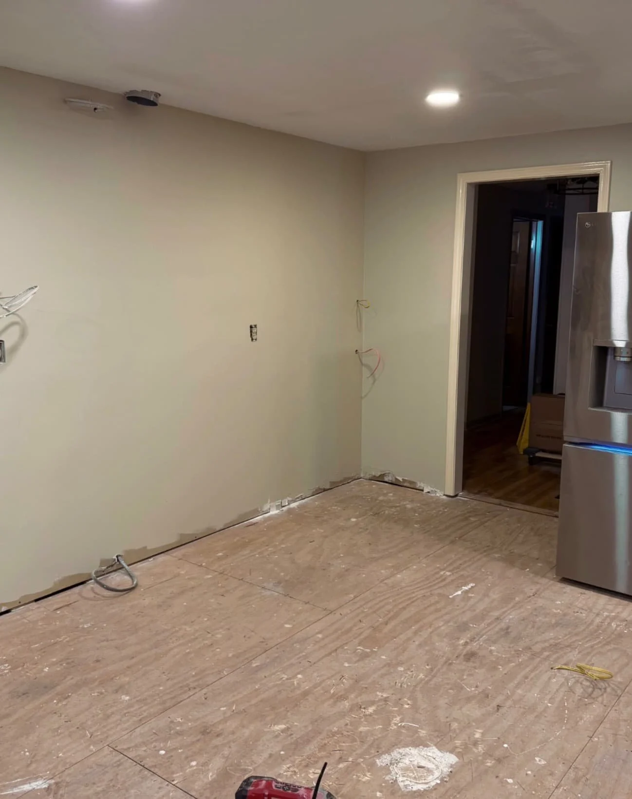 Kitchen renovation in a Fayetteville, NY home showing outdated flooring and an open interior layout for renovation.