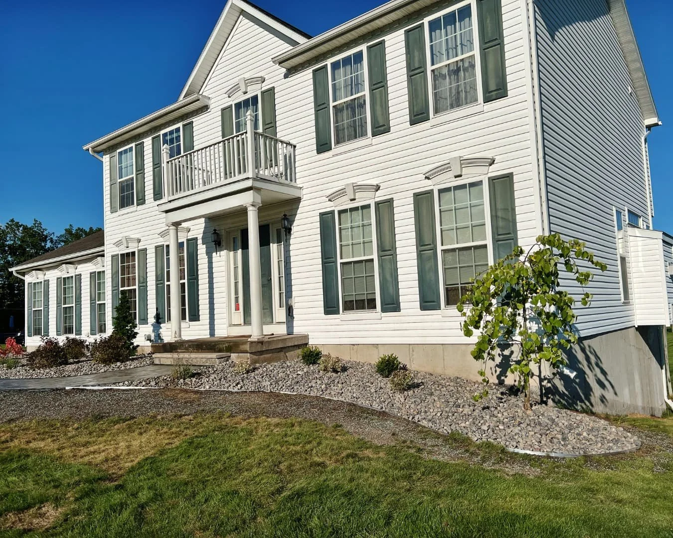 Front foundation landscape and walkway completed by Pines and Pavers in Baldwinsville, New York.