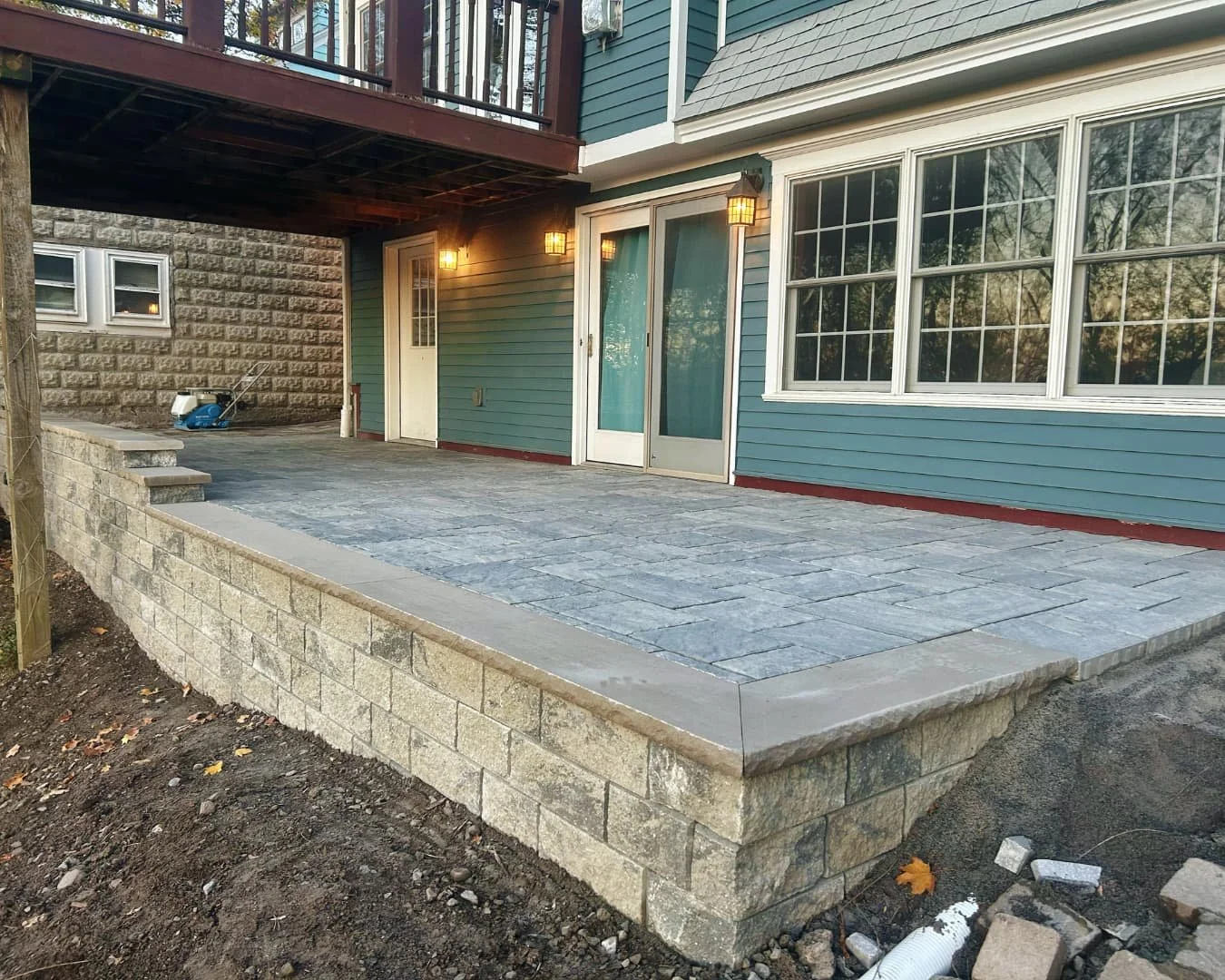 Covered patio with new paver surface installed by Pines and Pavers for a Central New York home.