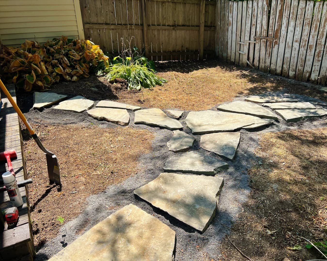 Natural stone patio and pathway completed by Pines and Pavers in Baldwinsville, New York.