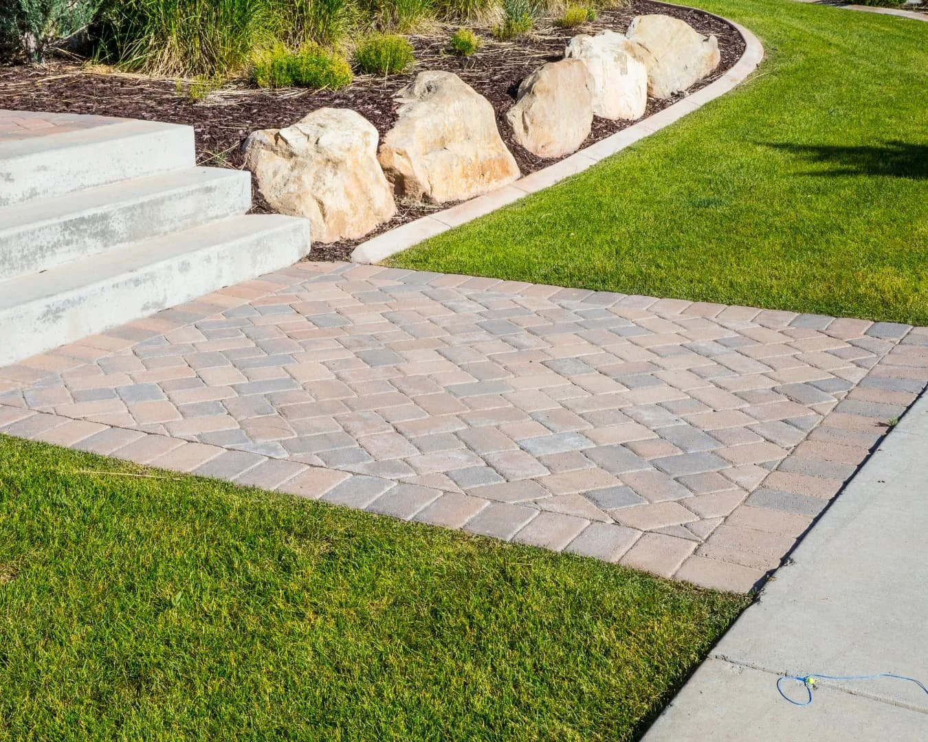 Walkway inspiration featuring a stone front door approach with clean symmetry and manicured foundation planting.